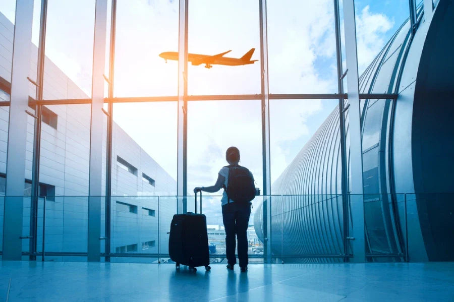 passenger silhouette waiting with luggage in airport