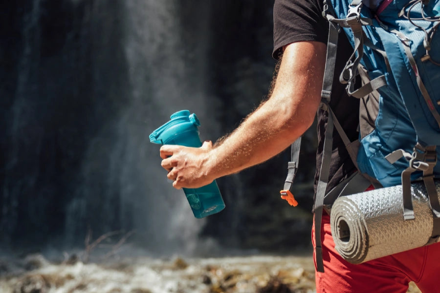 Closeup of a hiker holding a water bottle