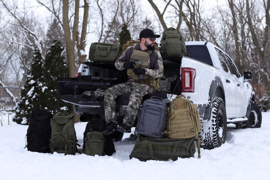 Military man in truck with tactical backpacks