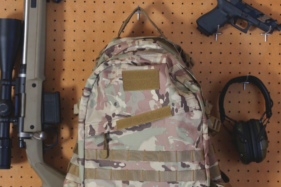 Tactical Gear and Camo Backpack Organized on a Wall